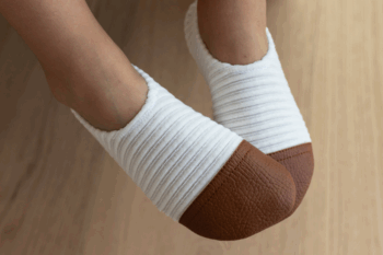 Les Petits Velours Ivoire aux pieds d'un enfant