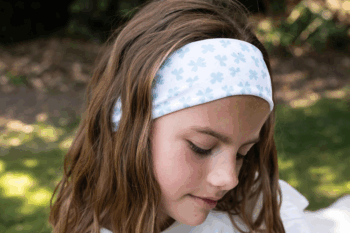 Bandeau au motif trèfles dans les cheveux d'une petite fille