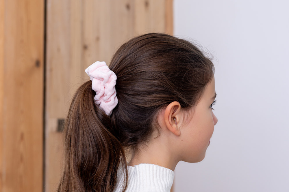 Chouchou velours pyjama rose pâle dans les cheveux