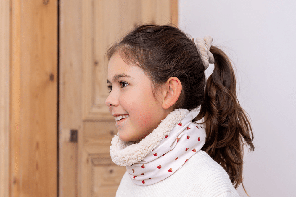 Les Petits Tours de cou Cœurs Bicolores avec doublure, au cou d'une petite fille